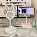 Soporte para teléfono móvil de escritorio con diseño de conejito de dibujos animados, ideal para estudiantes y personas perezosas.